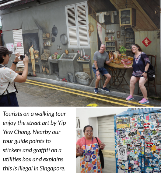 Tourists on a walking tour enjoy the street art by Yip Yew Chong. Nearby our tour guide points to stickers and graffiti on a utilities box and explains this is illegal in Singapore.